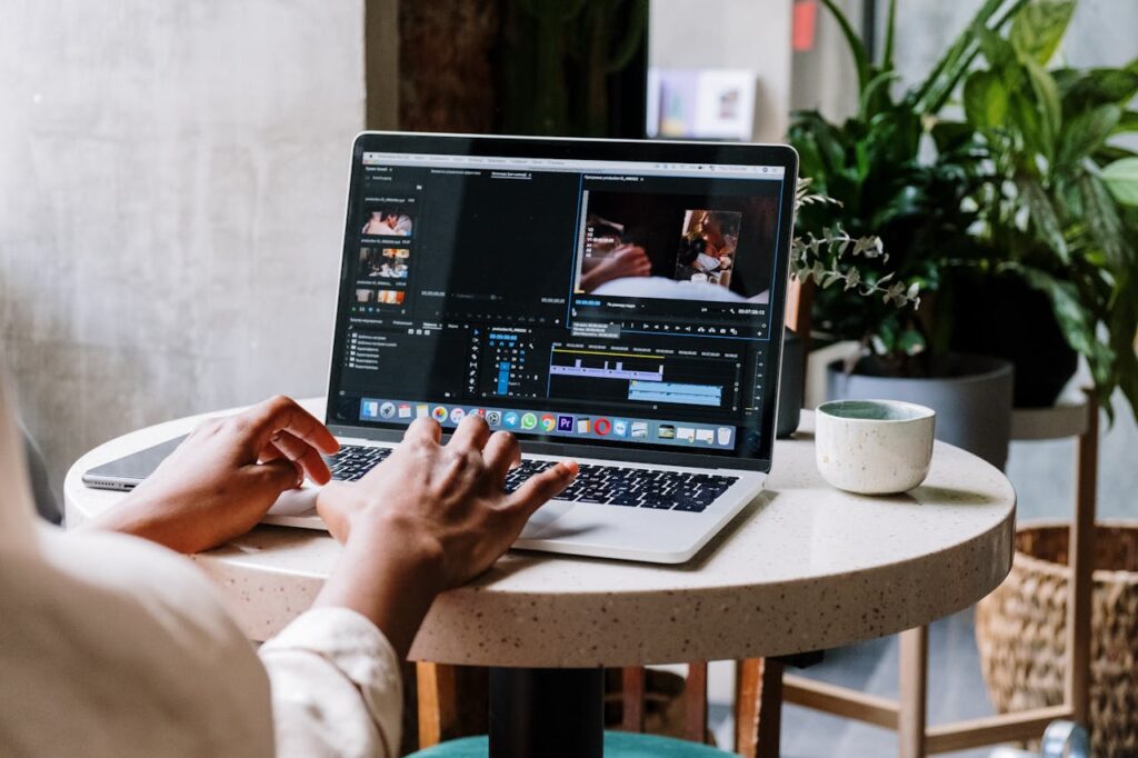 Person developing website on Macbook Pro on White Table
