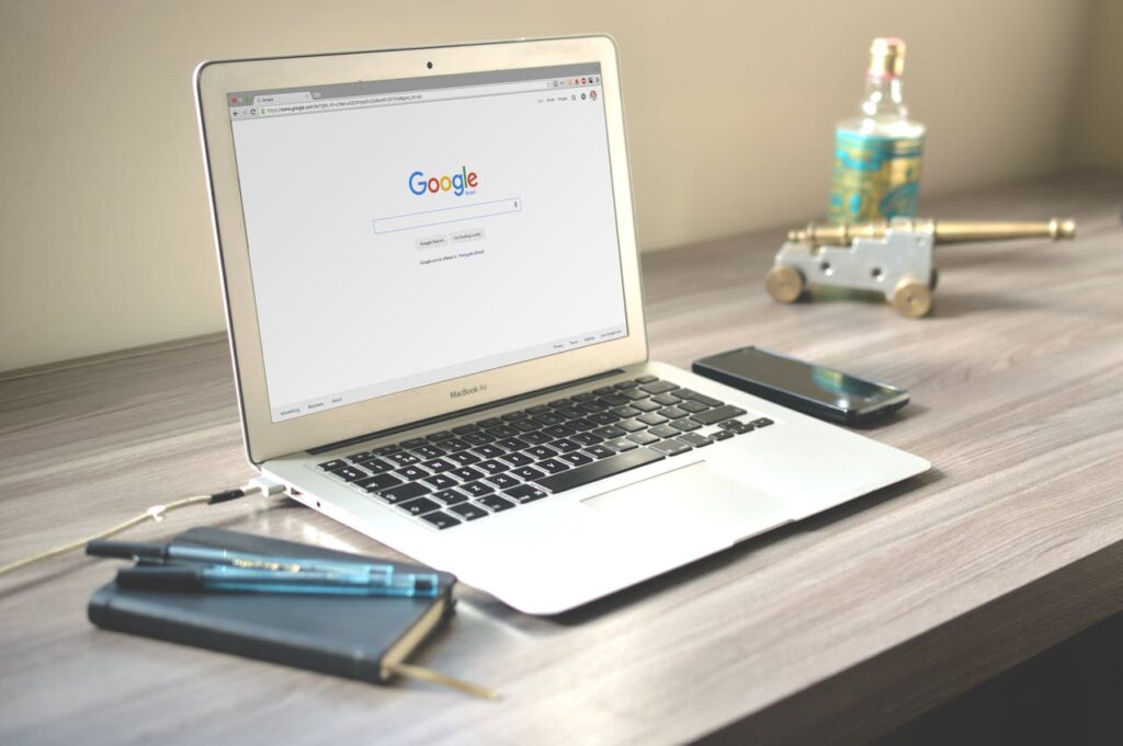 Macbook Air on Grey Wooden Table on Google